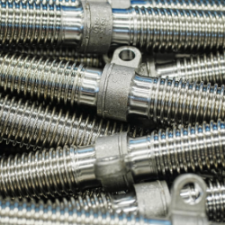 Close-up of metallic components for freight wagons, stacked in a box