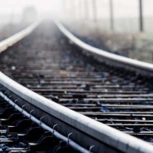 Blurred perspective of railway tracks stretching into the distance with blurred background